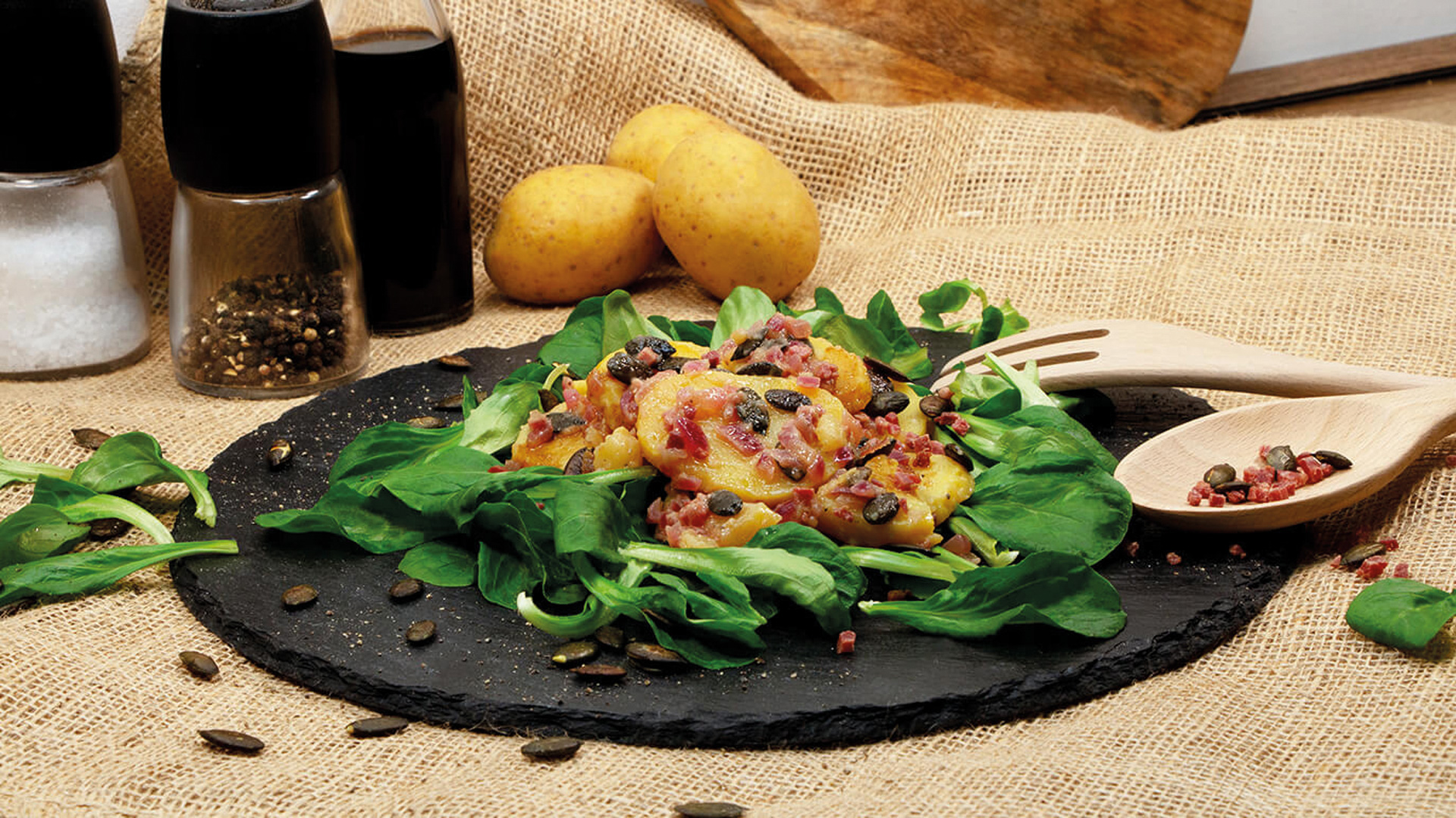 Winterlicher Kartoffelsalat mit Feldsalat, Kürbiskernen und Speck ...